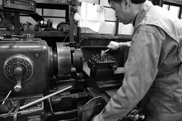 Small Japanese factory with skilled workers producing precision parts